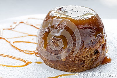 Sticky Toffee Pudding Close Up With Caramel Sauce Stock Photo