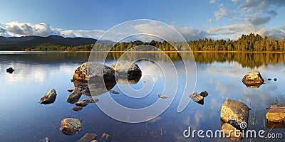 Still lake in early morning light, Loch Morlich, Scotland Stock Photo