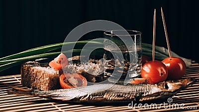 Still life alcoholic vodka fish tomato green onions Stock Photo