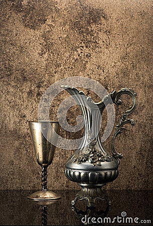 Still life with Ancient jug for wine and a silver goblet Stock Photo