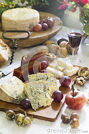 Still-life of Asturian blue cheese cabrales with sweet quince, nuts, hazelnuts, grapes, apple, and red wine Stock Photo