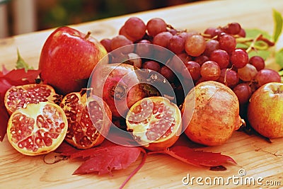 Still life of autumn fruits, with apples, grapes and pomegranate Stock Photo