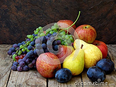 Still life of autumn fruits: grapes, apples, pear, plum Stock Photo