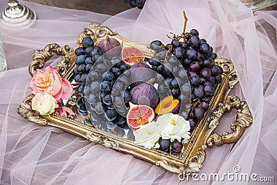 Still life: basket with grapes, figs and plums Stock Photo