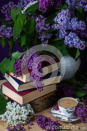 Still life books, coffee and lilacs in the dark key.Spring background Stock Photo