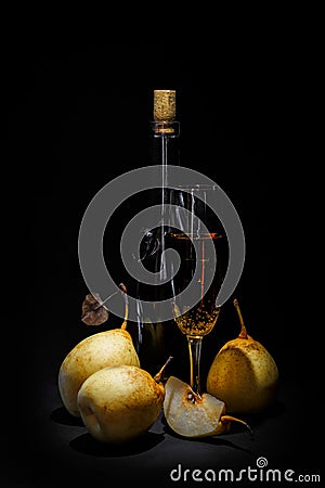 Still life; bottle of wine, whole pears and half on a dark background Stock Photo