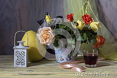 Still life with a bouquet of roses and a glass of homemade wine Stock Photo