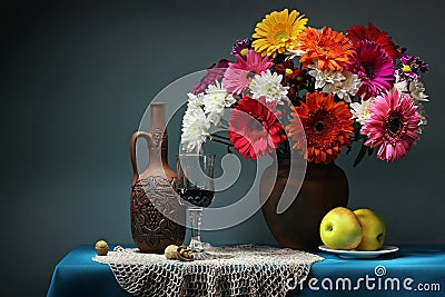 Still life with a bouquet and wine. Transvaal daisies. Stock Photo
