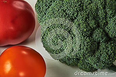 Still life with broccoli, yellow and red tomatoes Stock Photo