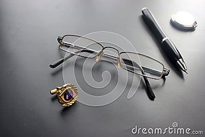 Still life, business, office supplies or education concept: a view of a recumbent padding, glasses, a pen, a clock, accessories Stock Photo