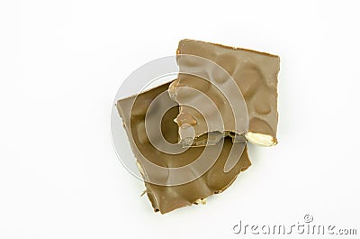 Still life with a close-up view of a broken table of milk chocolate with almonds isolated Stock Photo