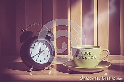 Still life of coffee cup and clack on table Stock Photo