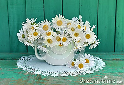 Still life with daisy flowers in white cup Stock Photo