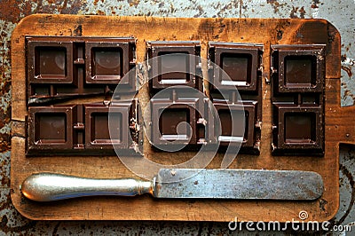 Still life with dark chocolate on a wooden board Stock Photo