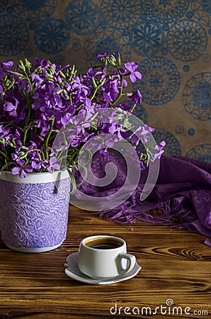 The bouquet of plant Matthiola farinosa and cup of coffee close-up Stock Photo