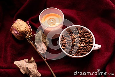 Still life with dried rose, candles, cup of coffee beans Stock Photo