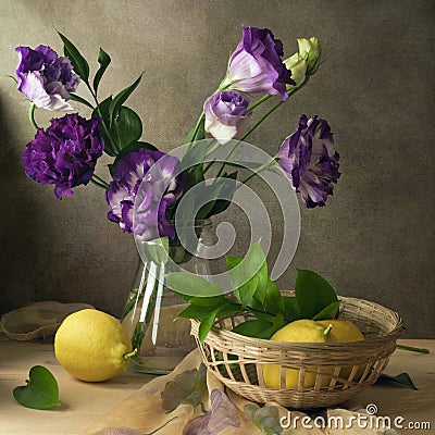 Still life eustoma purple flowers and lemons Stock Photo