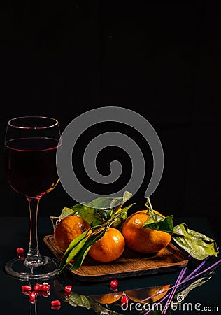 Still-life. a few tangerines on a wooden stand Stock Photo