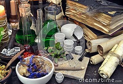 Still life with flasks, magic components, scrolls and books Stock Photo