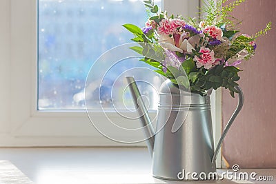 Still life flowers in watering can Stock Photo