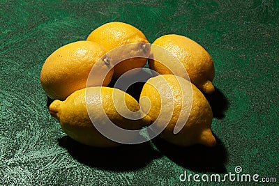 Greek lemons on emerald surface Stock Photo