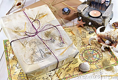 Still life with gift and hand drawn pirate map Stock Photo