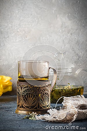 Still life with glass cup mug of tea in vintage retro stand and Stock Photo