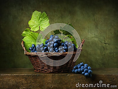 Still life with grapes in basket Stock Photo