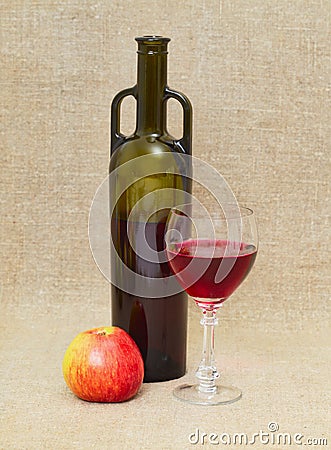 Still life with green bottle, apple and glass Stock Photo