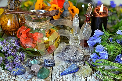 Still life with green witch herbs, potion, crystals and candles Stock Photo