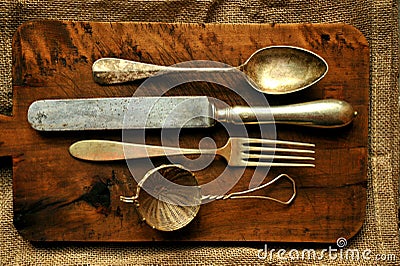 Still life image with old spoon, knife , fork and strainer Stock Photo