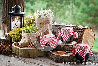 Still life with jars of fruit jam, vintage lamp Stock Photo