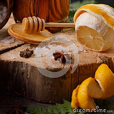 Still life with lemon and honey, on a wooden background in rustic style. The concept of spring avitaminosis and catarrhal diseases Stock Photo