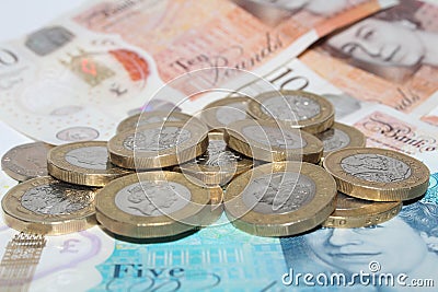 British money coins and notes of the realm sterling one pound coins and bank notes £10 pounds and £5 pounds close up Editorial Stock Photo
