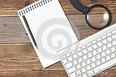 Still life with note pad, computer keyboard, magnifying glass an Stock Photo