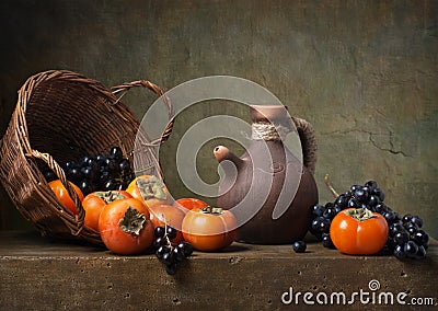 Still life with persimmons and grapes Stock Photo