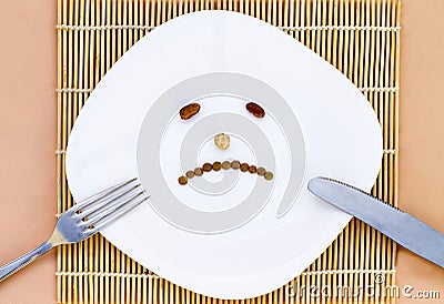 Sad dish, beans, fork and knive. concept of diet Stock Photo