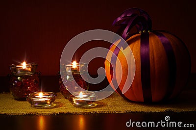 Still life with pumpkin in purple ribbons Stock Photo