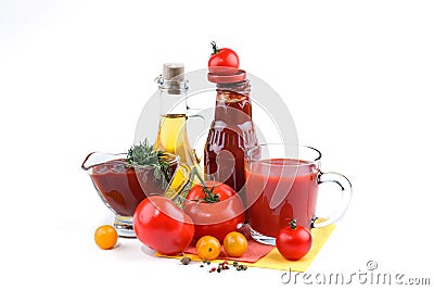 Still life of red and yellow tomatoes, bottle of tomato sauce and olive oil on white background. Stock Photo