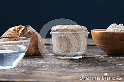 Still life setting with jar of sourdough starter yeast and bread ingredients Stock Photo