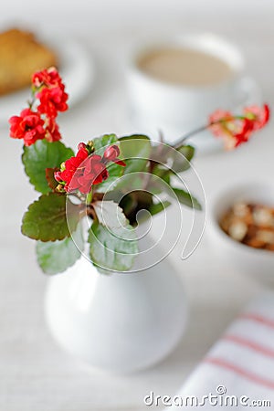 Still life with a small vase with wild flowers and food Stock Photo