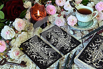 Still life with tarot cards layout, cup and candle Stock Photo