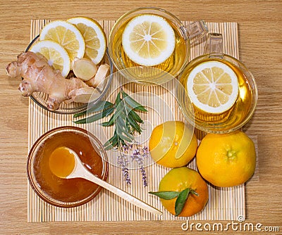 Still life. Tea in transparent cups. Honey, ginger, lemon and tangerines. From cold and flu. Stock Photo