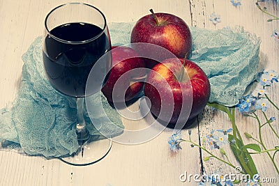 Still-life. Three apples, turquoise fabric and a glass of wine on a light background Stock Photo