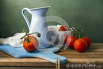 Still life with tomatoes and enamel jug Stock Photo