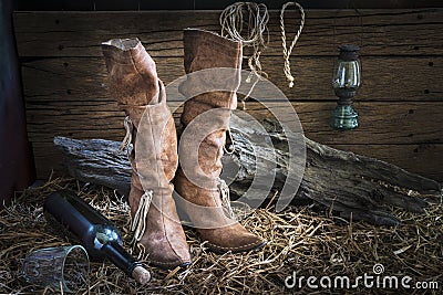 Still life with traditional leather boots in barn studio Stock Photo