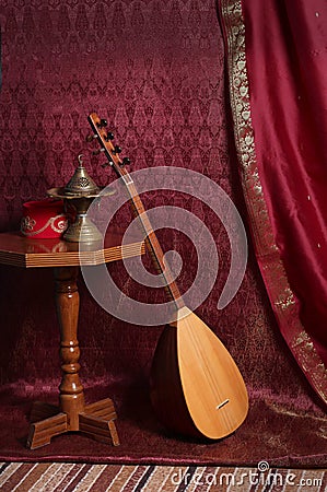 Still life in turkish oriental style. censer, fez, baglama saz on the table Stock Photo