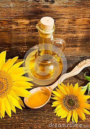 Still life with vegetable oil in a bottle and sunflowers Stock Photo