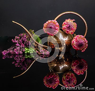 Still life of copper watering can and proteas Stock Photo