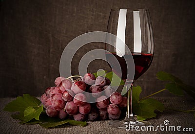 Still life with wine bottles, glasses and grapes Stock Photo